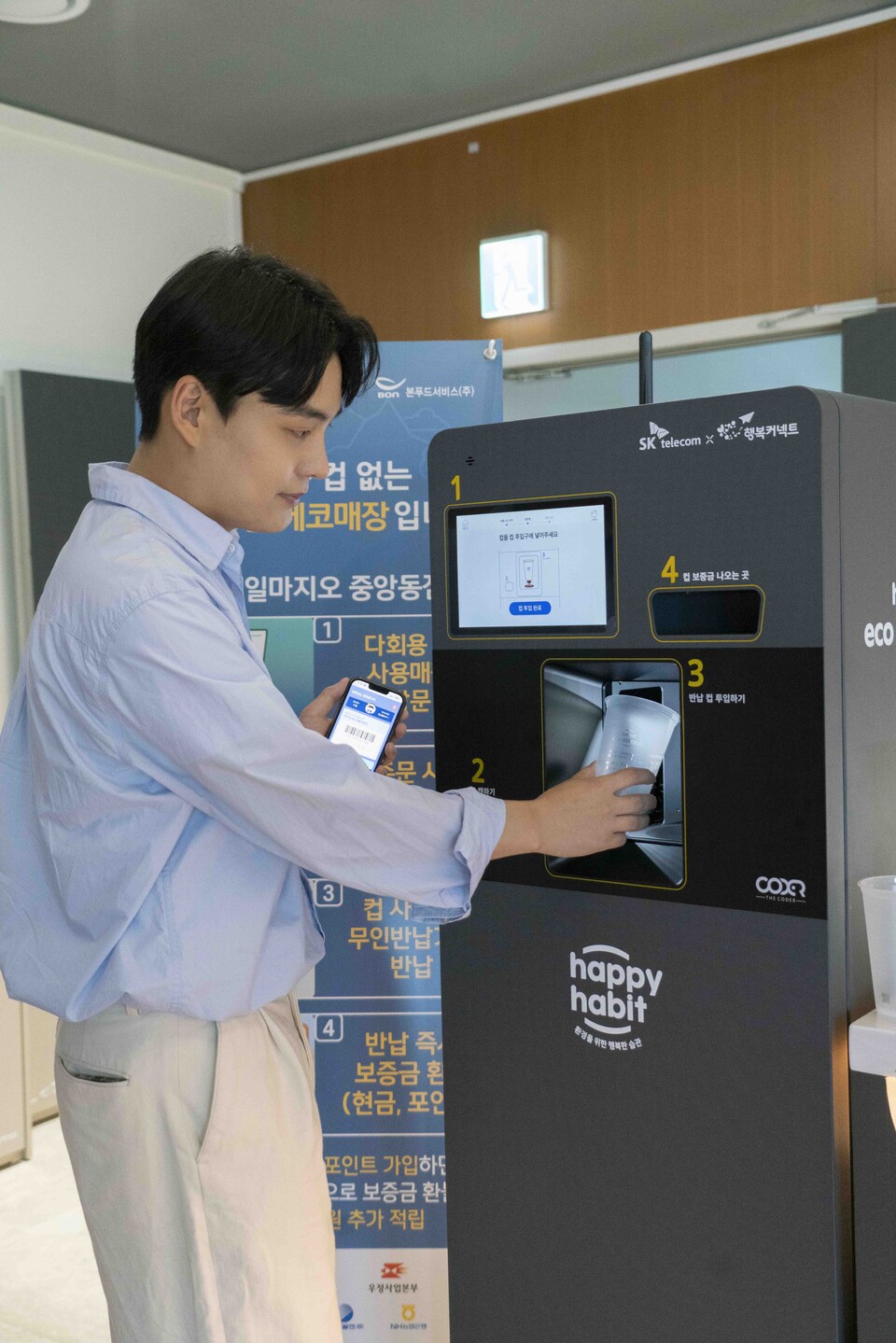 ▲SK텔레콤 모델이 정부세종청사 내부 카페 일마지오에서 다회용컵을 이용하고 무인 반납기를 통해 반납하고 있다. ⓒSK텔레콤