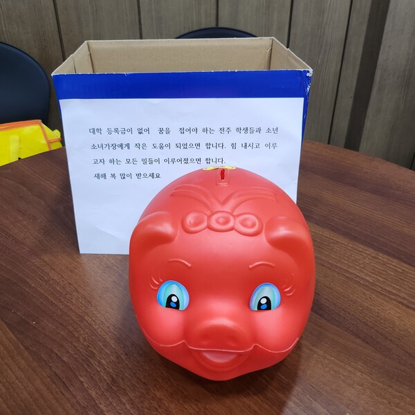 ▲‘얼굴 없는 천사’가 지난 2022년 전주시 노송동주민센터에 전달한 돼지저금통과 메시지. ⓒHD현대1%나눔재단