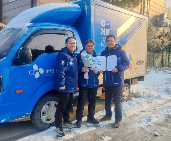 ▲CJ대한통운 택배기사 배철 씨(사진 가운데)가 남양주에서 화재를 막은 공로로 수령한 표창장을 들고 기념사진 촬영을 하고 있다. (사진 왼쪽부터) 김진우 화도A집배점장, 배철 택배기사, 김종민 남양주2지사장. ⓒCJ대한통운