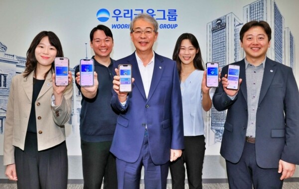 ▲임종룡 우리금융그룹 회장(가운데)이 지난 6일 유니버설뱅킹 신규 가입자 100만명 돌파를 기념해 직원들과 사진을 촬영하고 있다. ⓒ 우리금융지주