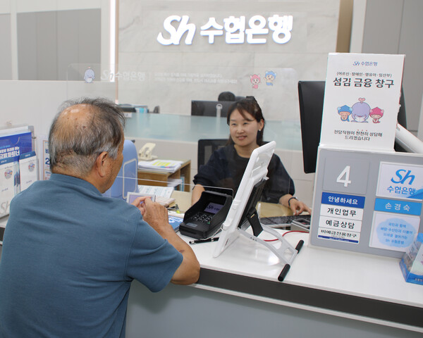 ▲Sh수협은행 영업점을 찾은 고령의 고객이 ‘어르신·장애인·영유아 동반 보호자·임산부 섬김금융 창구’에서 금융거래를 하고 있다. ⓒSh수협은행