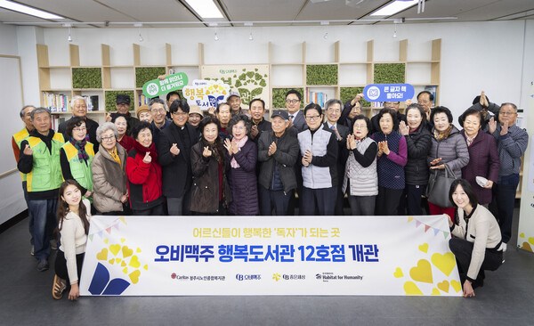 ▲20일 청주시노인종합복지관에서 오비맥주 행복도서관 12호점 개관식을 마치고 기념사진을 찍고 있다. ⓒ오비맥주