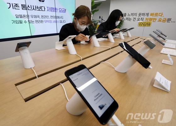 서울 서대문구 서대문역에 위치한 알뜰폰 스퀘어에서 직원들이 핸드폰 진열대를 소독 및 정리하고 있다.